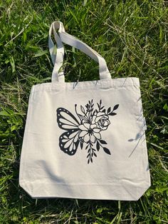 a white bag sitting on top of a lush green field