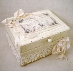 an old fashioned box with lace and ribbon