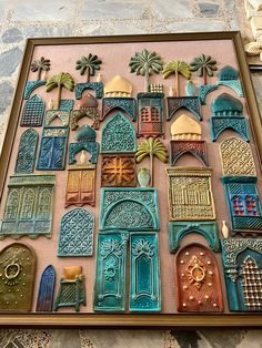 an intricately decorated wall with many doors and windows in different shapes, sizes and colors