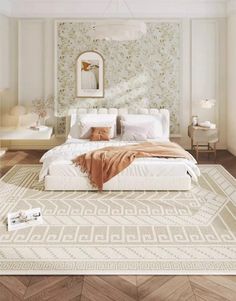 a large white bed sitting on top of a wooden floor