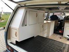 the back end of a van with cabinets in it