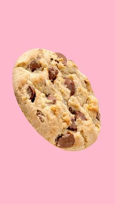 a chocolate chip cookie on a pink background