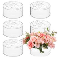 four clear vases with pink flowers in them on a white background, set of 4