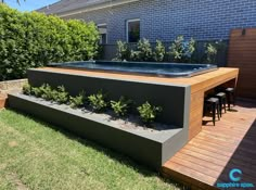 an outdoor hot tub in the middle of a yard with plants growing out of it