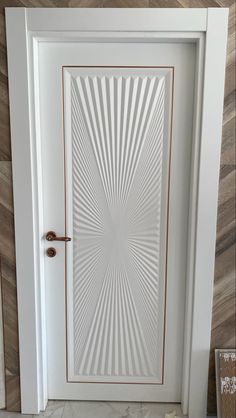 a white door with an intricate design on the front and side panels inlays