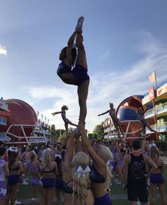 the cheerleaders are doing tricks for the crowd