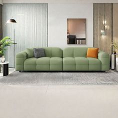 a modern living room with green couches and white rugs on carpeted flooring