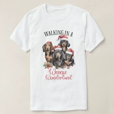 a white t - shirt with three dachshunds wearing santa's hats