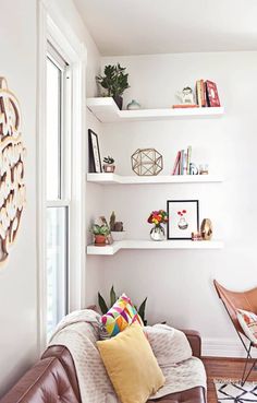 a living room filled with furniture and lots of shelves