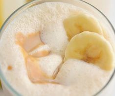 a glass filled with liquid and sliced bananas