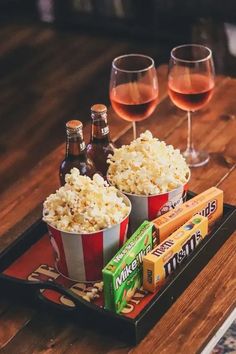 two glasses of wine and some snacks on a tray