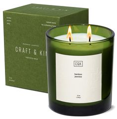 a green candle sitting next to a box on top of a white surface with the words craft and kit written in it