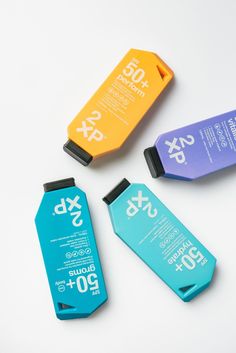 three different types of sunscreens sitting next to each other on a white surface