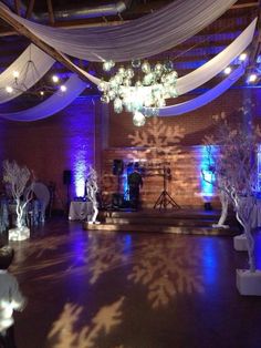 an indoor wedding venue with purple lighting and snowflakes