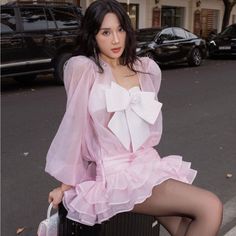 a woman sitting on top of a suitcase