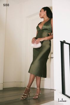 You'll be utterly unparalleled when you arrive in the Lulus Unmatched Elegance Olive Satin Cutout Sleeveless Midi Dress! Glossy woven satin dips low to a V-neckline at the center of a sleeveless bodice with figure-flattering princess seams and a sexy cutout detail at back, secured by a row of upscale covered buttons. High waist sits atop a midi skirt that sways like a dream as you strut across the dancefloor with a drink in hand! Hidden side zipper/clasp. Fit: This garment fits true to size. Length: Knee to mid-calf length. Size medium measures 48" from shoulder to hem. Bust: Great for any cup size. Waist: Fitted - very fitted at natural waist. Hip: Loosely Fitted. Undergarments: May be worn with petals, or no bra. Fabric: Fabric has no stretch. Lined. Shell: 100% Polyester. Lining: 97% Po Sleeveless Green Midi Dress For Gala, Olive Green Satin Dress, Spring Graduation Dress, Green Satin Dress, V Neck Midi Dress, Sleeveless Midi Dress, Princess Seams, Dress Satin, Satin Midi Dress