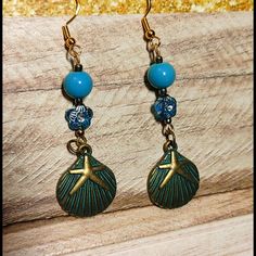 Adorable Long Dangle Earrings Featuring Aqua Blue & Rhinestones Beads With Antique Gold Tone Accents Antique Bronze No Rust Sea Shell Charm Earring Attaches To A Standard Hypo-Allergenic Fishhook Fitting Handmade, Nwot, Never Worn, Some Elements Upcycled From Vintage Pieces Smoke Free / Pet Free Environment This Item Qualifies For 10/$10 Offer! Blue Metal Beaded Drop Earrings, Blue Dangle Earrings With Ocean-inspired Style, Ocean-inspired Blue Dangle Earrings, Ocean-inspired Blue Earrings With Ear Wire, Blue Dangle Earrings For The Beach, Metal Beaded Drop Earrings For Beach, Beaded Metal Drop Earrings For Beach, Blue Metal Earrings With Dangling Beads, Blue Metal Beaded Dangle Earrings