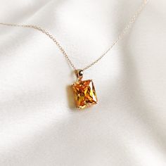 This stunning pendant is set in 14K Solid Deep Yellow Gold with AAA quality Deep Yellow Cubic Zirconia in classic prong setting. It is an unique gemstone pendant for nearly every occasion and is completely hassle-free jewelry. ◾ITEM DETAILS * Gem: Cubic Zirconia * Gem Size: 10X12mm * Gem Shape: Octagon * Gem Weight: 10.44 carats * Gold Purity: 14KT  * Gold Weight: 1.04gram * Total Weight of the Pendant: 3.13 gram The Gold purity is guaranteed and it comes with authentic 14KT gold hallmark. Since my items are handmade, they are absolutely nickel and lead free. ◾CUSTOMIZATION Gemstone customization is available and it can be substituted with a gem of your choice. Kindly message me for the same. ◾PACKAGING The Pendant comes with layers of safe and secure wrapping along with Free handmade jewe Luxury Gold Necklace With Radiant Cut, Gold Solitaire Necklace With Emerald Cut Diamond Accents, Gold Solitaire Necklace With Emerald-cut Diamond Accents, Dazzling Cushion Cut Yellow Gold Jewelry, Luxury Crystal Solitaire Necklace As Gift, Luxury Crystal Solitaire Necklace Gift, Gold Cubic Zirconia Necklace With Radiant Cut, Gold Radiant Cut Cubic Zirconia Necklaces, Gold Radiant Cut Cubic Zirconia Necklace