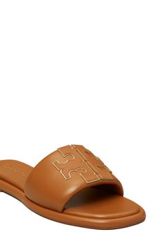 A sleek leather slide accented by Tory's signature double-T logo is ready to upgrade your warm-weather style. Leather upper and lining/rubber sole Imported Luxury Leather Slides With Tang Buckle, Brown Leather-lined Slides For Summer, Luxury Leather-lined Open Toe Slides, Luxury Leather-lined Slide Sandals, Luxury Gold-tone Hardware Calf Leather Sandals, Leather Slides, Slide Sandals, Warm Weather, Tory Burch