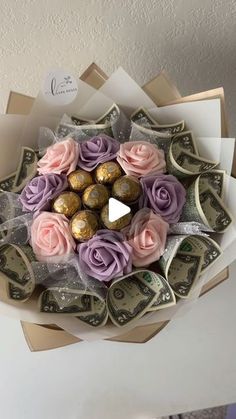 a bouquet of roses and chocolates is wrapped in dollar bills for someone's special gift