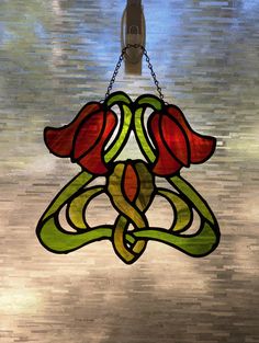 a stained glass window hanging from a chain