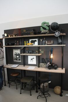 a woman standing in front of a shelf with various items on it