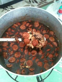 a pot filled with lots of food on top of a stove