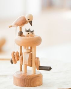 a wooden toy with birds perched on top of it