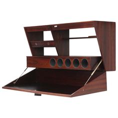 a wooden desk with an open drawer on the top and two holes in the bottom