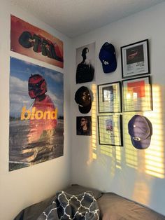 a bedroom with posters and pictures on the wall