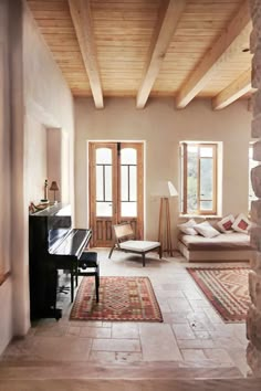 a living room filled with furniture and a piano