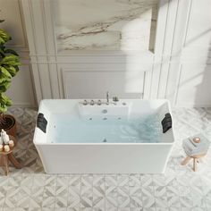 a large white bath tub sitting next to a potted plant on top of a tiled floor