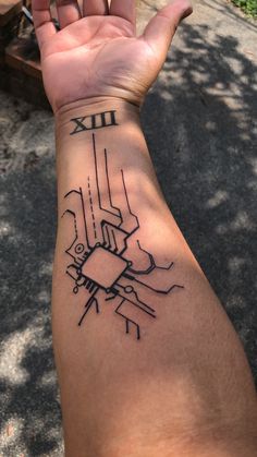 a person's arm with a wrist tattoo that has a circuit board on it