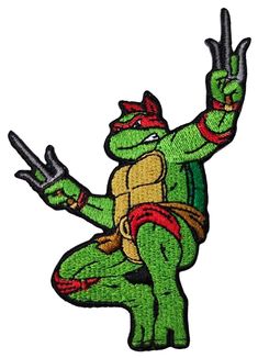 a teenaged ninja turtle holding two knives in one hand and pointing to the side