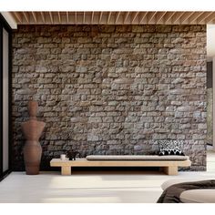 a living room with a couch and stone wall