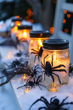 some mason jars with spider lights in them