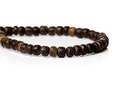 "These beads are made of coconut wood and measure 4mm in diameter. Coconut beads are considered ecological because they use a renewable resource and are biodegradable. Quantity: 1 strands of approx. 140 beads - 15 6/8 inches (40cm long) Color: brown Material: wood coconut Size: 4mm diam. Thickness: 4.5mm ( 1/8\") - 1.4mm Hole size: 1mm Condition:  new beads Shape :  round - each bead is different    SEE ALL WOODEN BEADS: www.etsy.com/shop/BHJewelryMaking?section_id=11452255 Free shipping on all Brown Wooden Beaded Bracelets With Round Beads, Brown Wood Beaded Bracelets With Round Beads, Brown Wooden Beaded Bracelets, Brown Rustic Beaded Bracelets With Round Beads, Rustic Brown Beaded Bracelets With Wooden Beads, Rustic Brown Wooden Beaded Bracelets, Hypoallergenic Necklace, Wholesale Jewelry Supplies, Coconut Wood