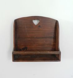 a wooden shelf with a heart cut out on it