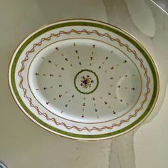 a white and green bowl sitting on top of a counter