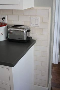 a toaster sitting on top of a counter in a kitchen