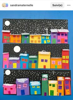 an art project made out of paper and colored houses on a blue background with snow