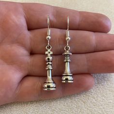 Quirky silver plated dangle/ drop earrings with chess piece charms You can pick from: - Mix and match: King and queen chess pieces - Queen chess pieces - King chess pieces  925 stamped sterling silver earring hooks also available Comes in an organza bag 💫💫 Chess Jewelry, Chess Earrings, King And Queen Chess Pieces, King Chess, Queen Chess, Queen Chess Piece, Ears Pierced, Queen Earrings, Chess Queen