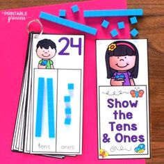 two children's bookmarks with the numbers twenty and one, on top of pink paper