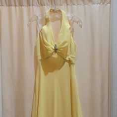 New Never Worn Yellow Halter Long A-Line Dress With Brooch On The Bodice Fitted Halter Neck Chiffon Dress For Spring, Yellow V-neck Chiffon Dress For Party, Yellow V-neck Chiffon Party Dress, Chiffon Halter Neck Evening Dress, Elegant Yellow A-line Evening Dress, Flowy Halter Neck Evening Dress, Yellow Cocktail Dress With Fitted Bodice, Chiffon Dress For Formal Occasions, Yellow Chiffon Prom Dress