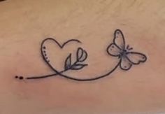 a tattoo on the back of a woman's stomach with two butterflies and a heart