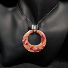 "From day-to-day, to special occasions, this intriguing piece will complement any style.  Hand crafted in polymer clay, and finished with crystal clear domed resin, and a silvered acrylic bead, this pendant is light and easy to wear. This piece is part of a small-batch unrepeatable colourway, and would make a great gift for a loved one, or for yourself (you deserve nice things too, you know!) This piece comes mounted on black cotton 1.5mm cord, adjustable from approx 76cm (30ins) to 40cm 15.75ins).  However, you can request any length of cord - just leave a message in the \"note to seller\" section at checkout.  If you would prefer the pendant mounted on a cord with adjustable lobster clasp, please add the item \"waxed cotton cord necklace\" to your basket, and please remember to state wha Orange Circular Jewelry As A Gift, Orange Circular Jewelry Gift, Multicolor Resin Round Jewelry, Multicolor Round Resin Jewelry, Silver Polymer Clay Pendant Necklace, Modern Orange Necklace For Gift, Modern Multicolor Resin Jewelry, Modern Orange Necklace As Gift, Unique Resin Pendant Necklaces