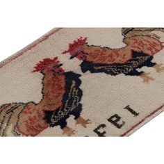 a rug with two roosters on it