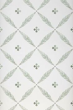 a white and green patterned wallpaper with diamond shaped designs on it's sides