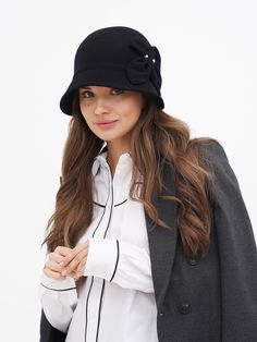 Discover the timeless elegance of our Women's Winter Cloche Hat, a perfect blend of classic style and modern comfort. Inspired by the iconic flapper era, this wool hat is a nod to the glamorous Gatsby days, bringing a touch of vintage charm to your wardrobe. Available in two sophisticated colors - classic black and a deep, dark blue - this hat is designed to complement any outfit, whether you're dressing up for a special occasion or adding a stylish accent to your everyday wear. Crafted with the highest quality wool, our cloche hat promises not only style but also warmth and comfort during the colder months. The wool fabric is carefully selected for its softness and durability, ensuring that the hat maintains its shape and elegance over time. The snug fit of the cloche design is both pract Luxury Wool Brimmed Cloche Hat, Luxury Brimmed Wool Cloche Hat, Luxury Classic Cloche Hat For Fall, Luxury Casual Brimmed Cloche Hat, Luxury Women's Cloche Felt Hat, Luxury Wool Classic Cloche Hat, Chic Luxury Cloche Hat For Women, Luxury Classic Cloche Hat With Curved Brim, Luxury Chic Cloche Hat For Women