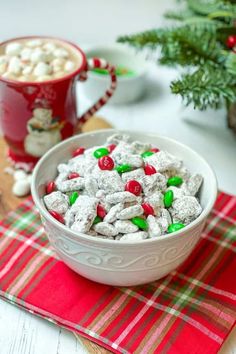 a white bowl filled with candy and marshmallows on top of a table